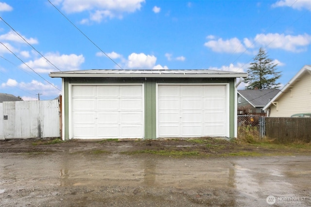 detached garage featuring fence