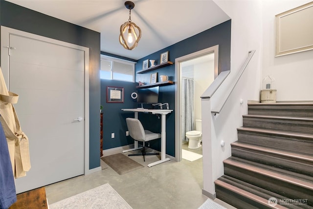 office with concrete floors and baseboards