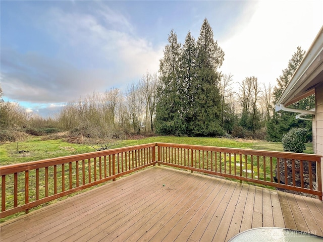 wooden terrace featuring a yard