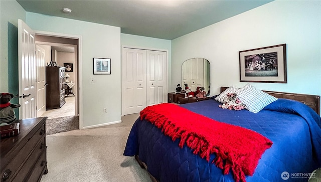 bedroom featuring baseboards, a closet, and light colored carpet