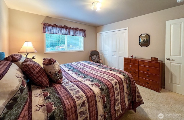 bedroom with light carpet and a closet