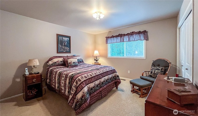 bedroom featuring a closet, carpet flooring, and baseboards