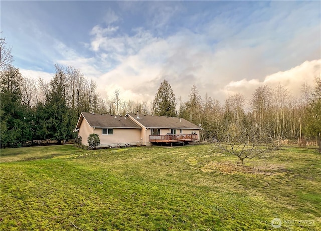 view of front of property with a front lawn and a wooden deck