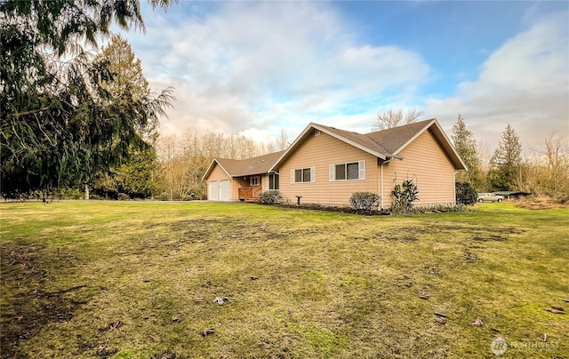 view of side of home with a lawn