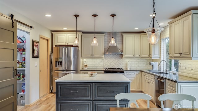 kitchen featuring a kitchen island, pendant lighting, a sink, and cream cabinets