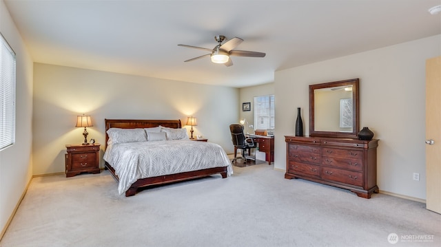 bedroom with light carpet, baseboards, and a ceiling fan