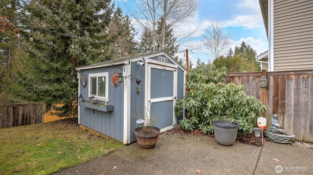 view of shed with a fenced backyard