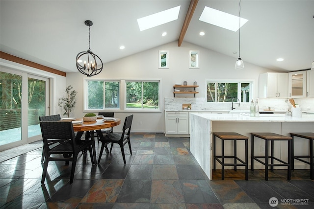 dining room with recessed lighting, stone tile flooring, baseboards, and beam ceiling