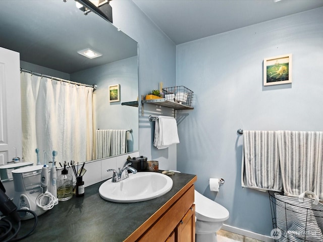 full bathroom featuring radiator heating unit, baseboards, vanity, and toilet