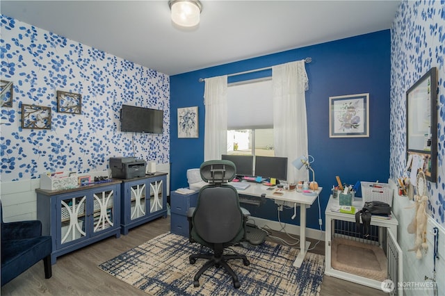 office space featuring dark wood-type flooring, an accent wall, baseboards, and wallpapered walls