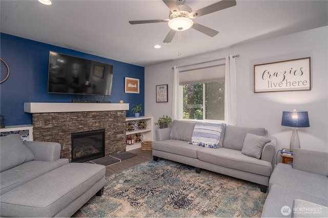 living room with ceiling fan, recessed lighting, a fireplace, and wood finished floors