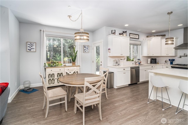 dining area featuring recessed lighting, baseboards, and wood finished floors