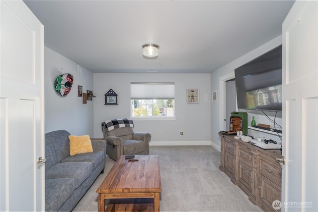 living area featuring light colored carpet and baseboards