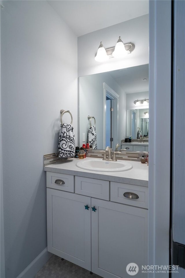 bathroom with baseboards and vanity