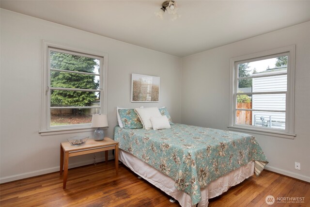 bedroom with baseboards and wood finished floors