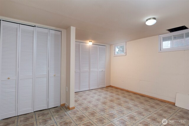 unfurnished bedroom featuring multiple windows and baseboards