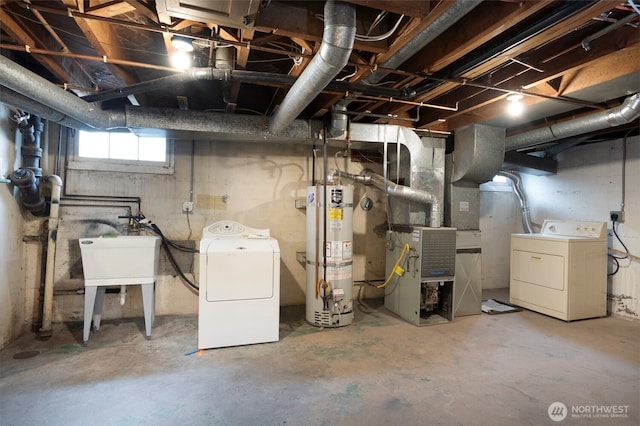 basement with heating unit, secured water heater, a sink, and washer and dryer