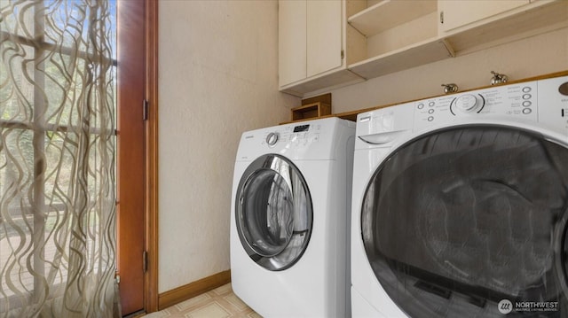 laundry area featuring washing machine and dryer, baseboards, light floors, and laundry area