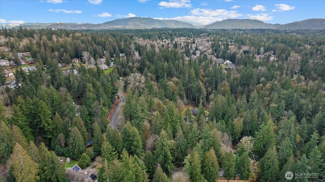 bird's eye view with a mountain view and a wooded view