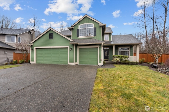 view of front facade with roof with shingles, an attached garage, a front yard, fence, and driveway