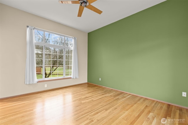 unfurnished room with light wood-type flooring and ceiling fan