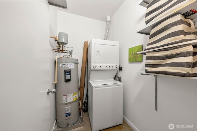 clothes washing area featuring stacked washer / dryer, laundry area, water heater, and baseboards