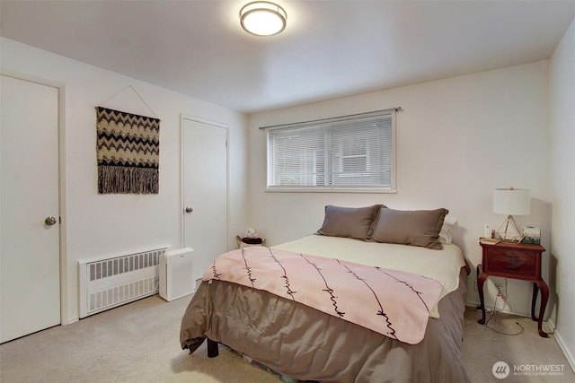 carpeted bedroom featuring radiator