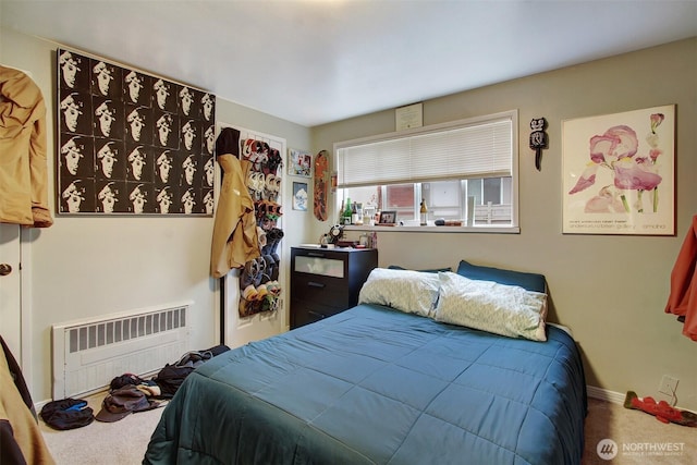 bedroom with carpet and radiator heating unit