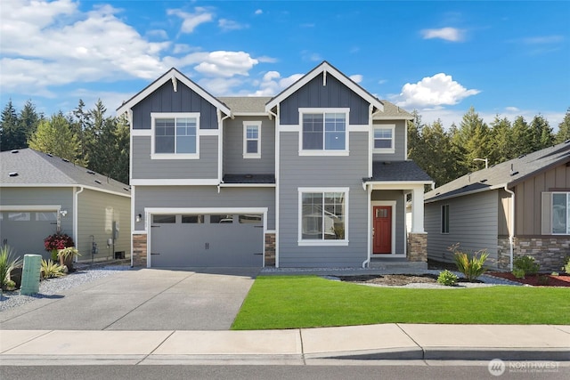 craftsman-style house featuring a garage, concrete driveway, board and batten siding, and a front yard