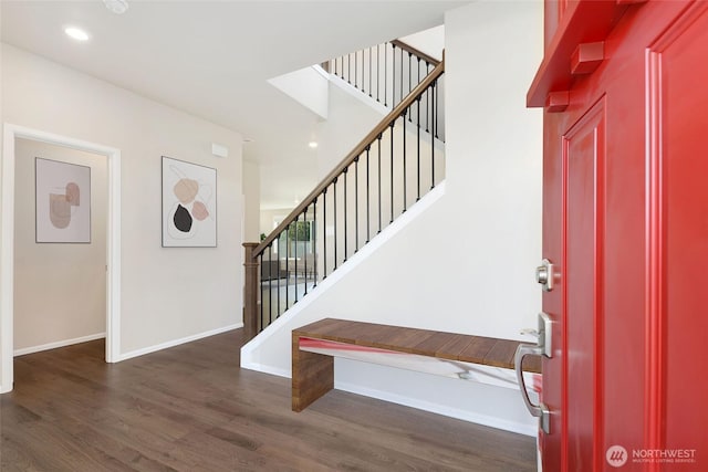 foyer entrance with stairway, recessed lighting, dark wood finished floors, and baseboards