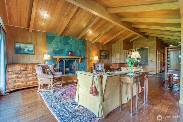 living area featuring lofted ceiling with beams, wooden walls, wood ceiling, and hardwood / wood-style flooring