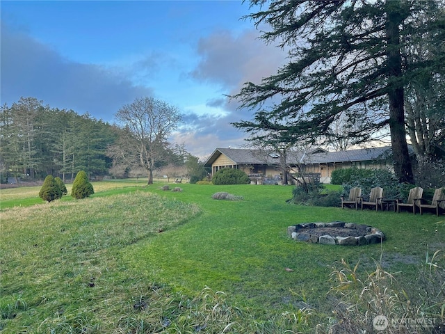 view of yard with a fire pit