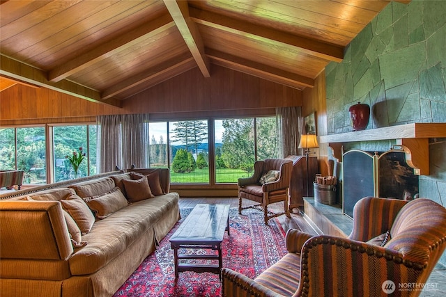 living room featuring a tile fireplace, wood walls, wood finished floors, vaulted ceiling with beams, and wood ceiling