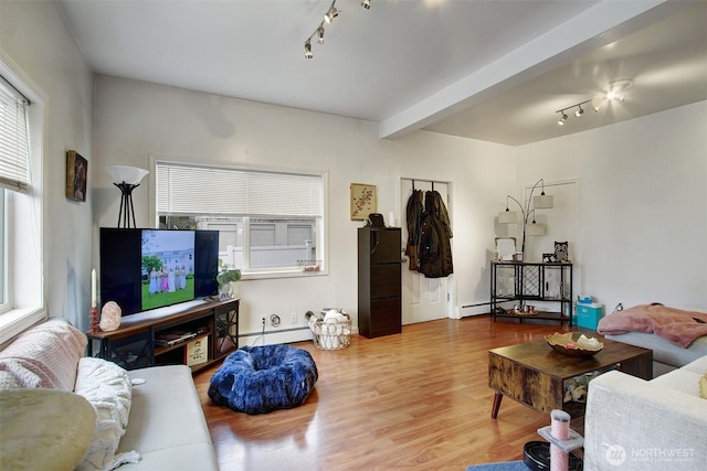 living room with baseboard heating, rail lighting, hardwood / wood-style flooring, and beam ceiling