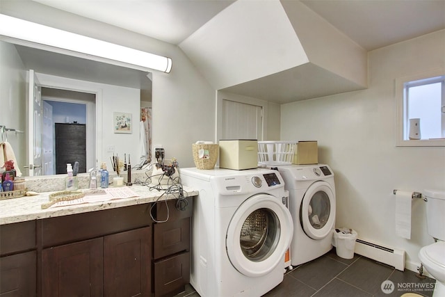 laundry room featuring sink, independent washer and dryer, dark tile patterned flooring, and baseboard heating