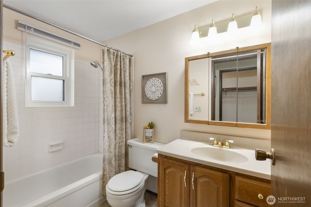 full bath featuring shower / bath combo with shower curtain, vanity, and toilet