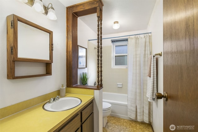 bathroom featuring toilet, shower / bathtub combination with curtain, and vanity