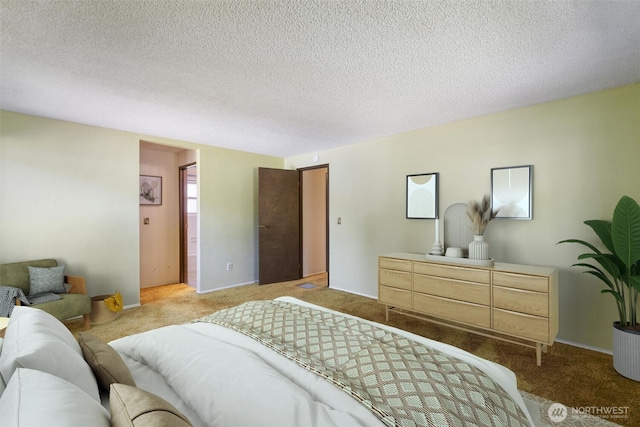 bedroom with carpet, baseboards, and a textured ceiling