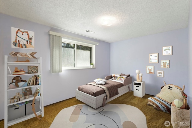 bedroom with carpet, visible vents, and a textured ceiling