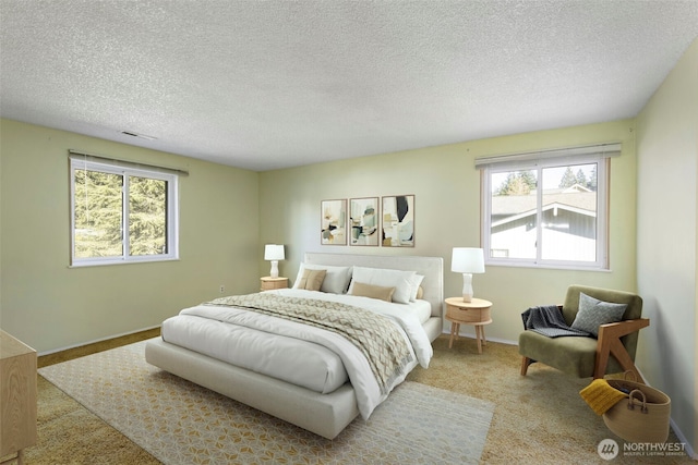 bedroom with carpet, a textured ceiling, and baseboards