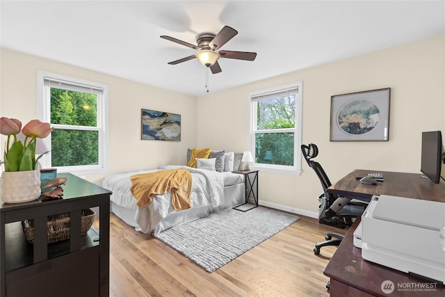 bedroom featuring light wood-type flooring, ceiling fan, and baseboards