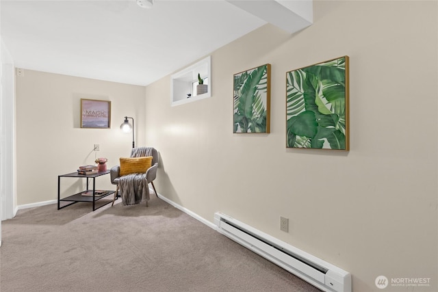 sitting room featuring a baseboard radiator, light colored carpet, and baseboards