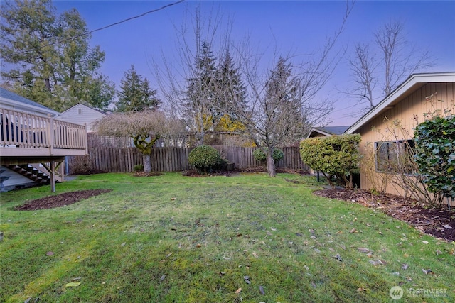 view of yard with a fenced backyard and a wooden deck