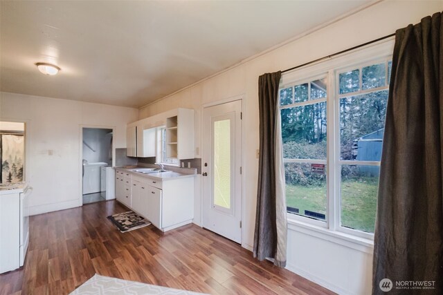 kitchen with light countertops, dark wood-style flooring, white cabinetry, and open shelves