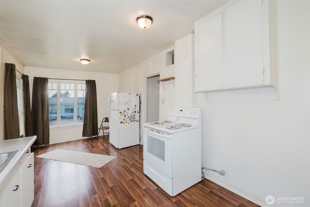 kitchen with white appliances, white cabinetry, light countertops, and dark wood-type flooring