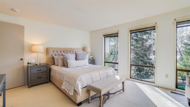 bedroom featuring light carpet, multiple windows, and visible vents