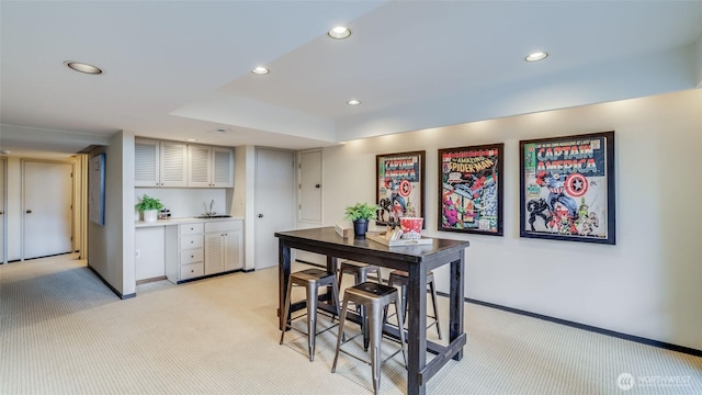 dining space featuring recessed lighting, light colored carpet, and baseboards