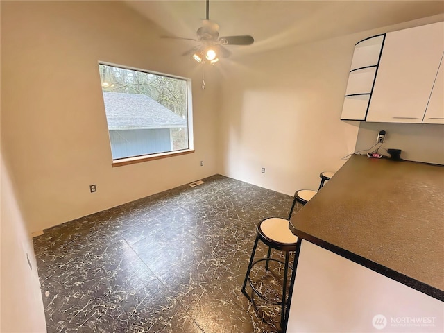 unfurnished dining area with visible vents and ceiling fan