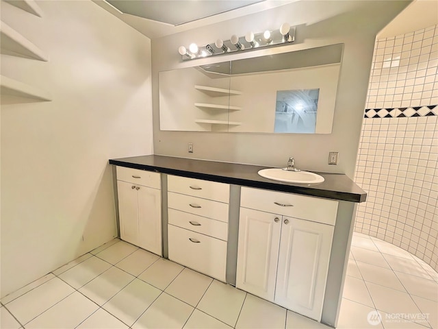 bathroom with tile patterned flooring and vanity