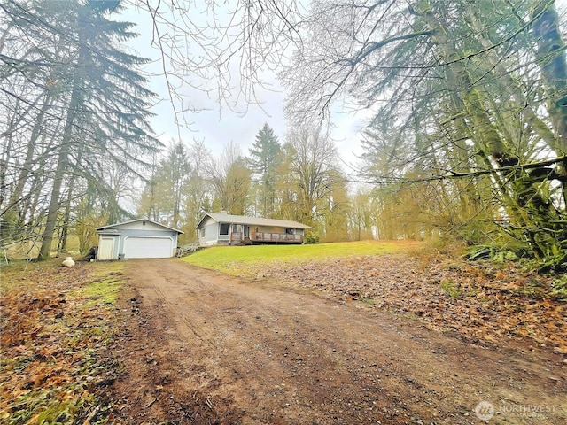 ranch-style house with a garage, a front yard, and driveway